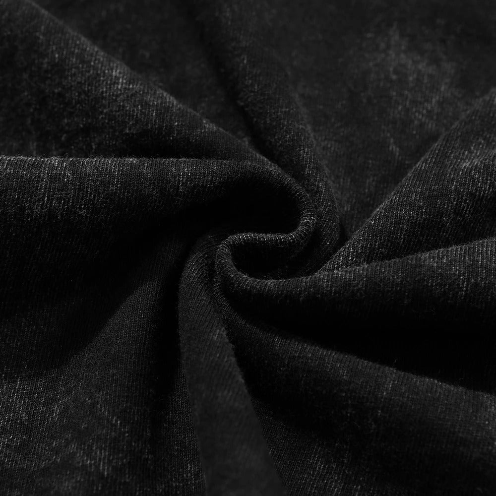 Macro shot of swirled heavy 240 GSM cotton fabric showing the premium density and vintage black acid wash grain
