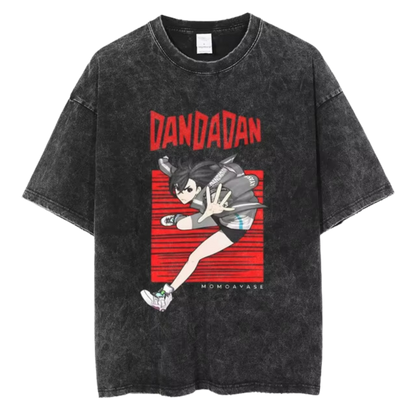 A black t-shirt with a distressed print of Okarun, a character from the manga series "Dandadan." He is depicted in a dynamic pose, with the word "DANDAN" written in red letters above him.