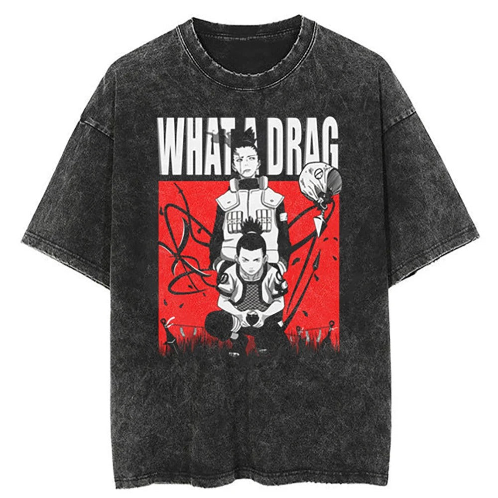 A black t-shirt with a distressed print featuring Shikamaru Nara from Naruto, with the text "What a Drag" above him. The image also includes Choji Akimichi and Ino Yamanaka in the background.