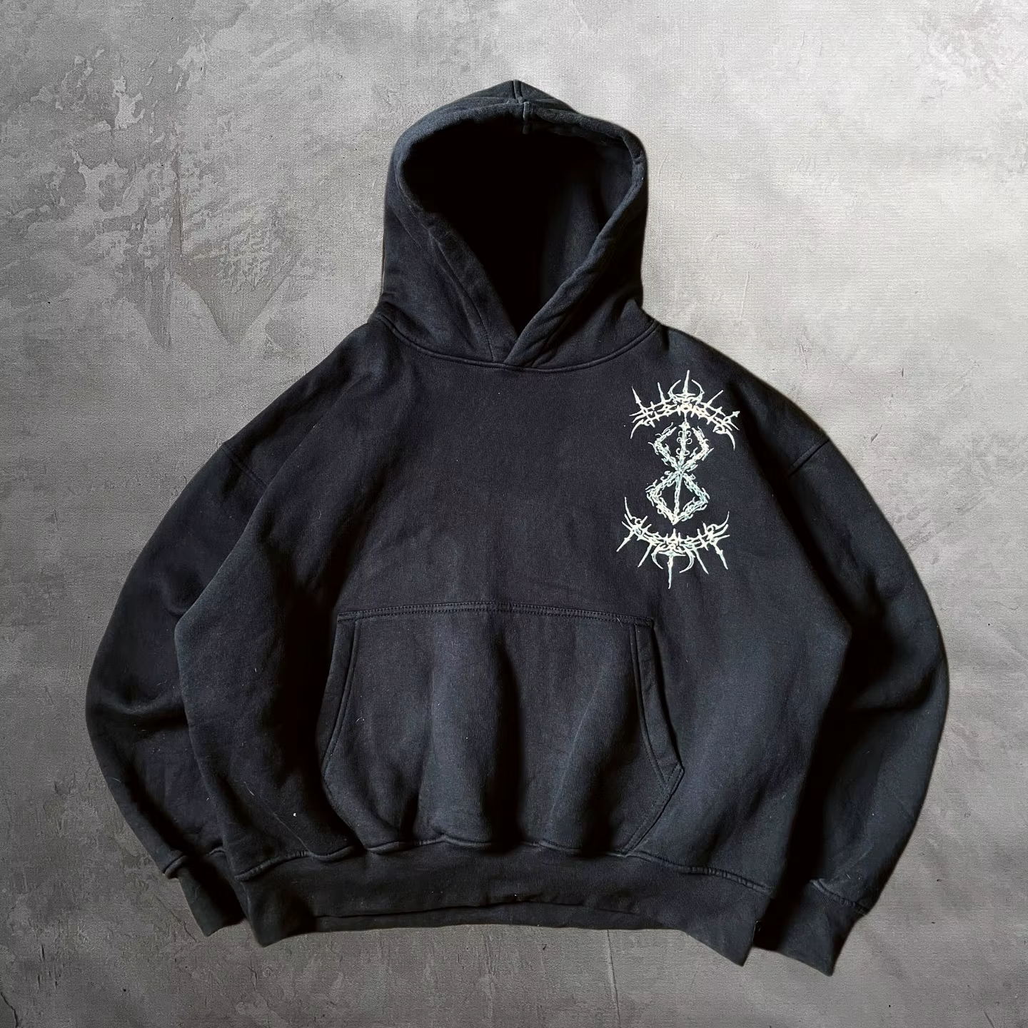 Front view of a premium black heavyweight pullover hoodie with a Berserk Brand of Sacrifice chest graphic.