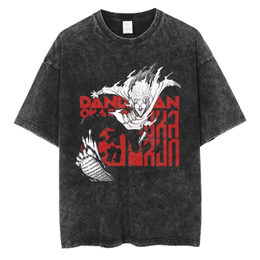 A black t-shirt with a distressed print of Okarun, a character from the manga series "Dandadan." He is depicted in a dynamic pose, with the word "DANDAN" written in red letters above him.