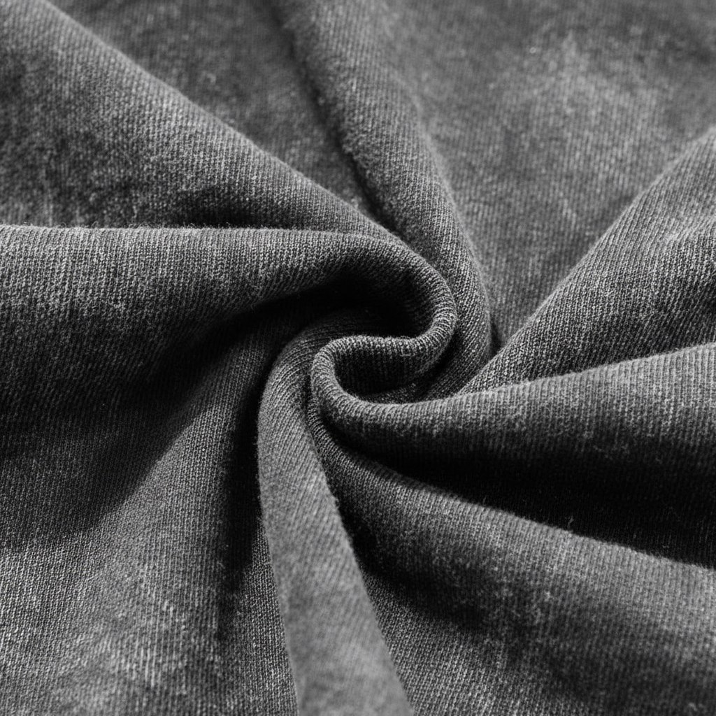 Close up of distressed frayed ribbed collar on a vintage grey acid wash heavyweight t-shirt.
