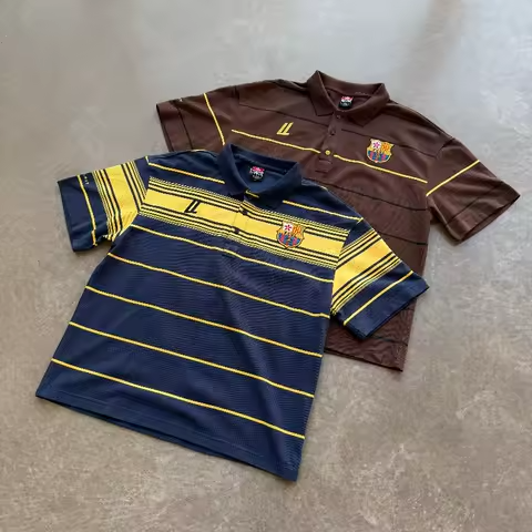 Flat lay view of the Navy and Mocha striped oversized terrace polos highlighting the premium textured fabric and high-density embroidery.