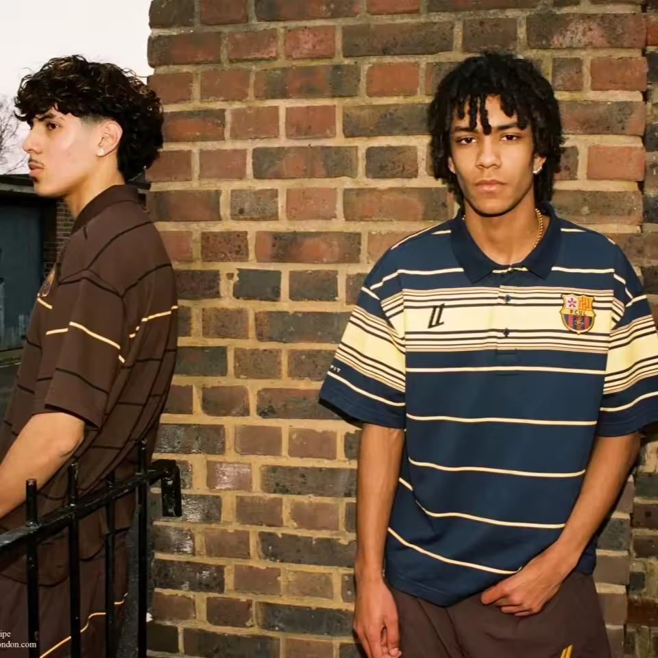 Two models showcasing the Navy/Yellow and Mocha brown striped oversized tech polos from the FCUL Terrace Collection.