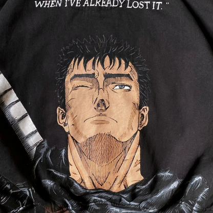 Close-up of the Guts portrait and 'Why do I always realize it' quote printed on a black heavyweight hoodie.