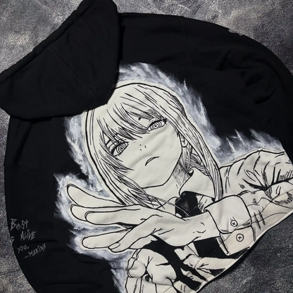 Angled view showing the Makima back graphic and custom sleeve text embroidery on a black streetwear zip-up hoodie.