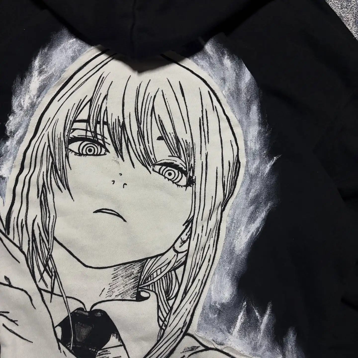 Detailed close-up of the Makima manga character graphic print on the back of a black streetwear hoodie.
