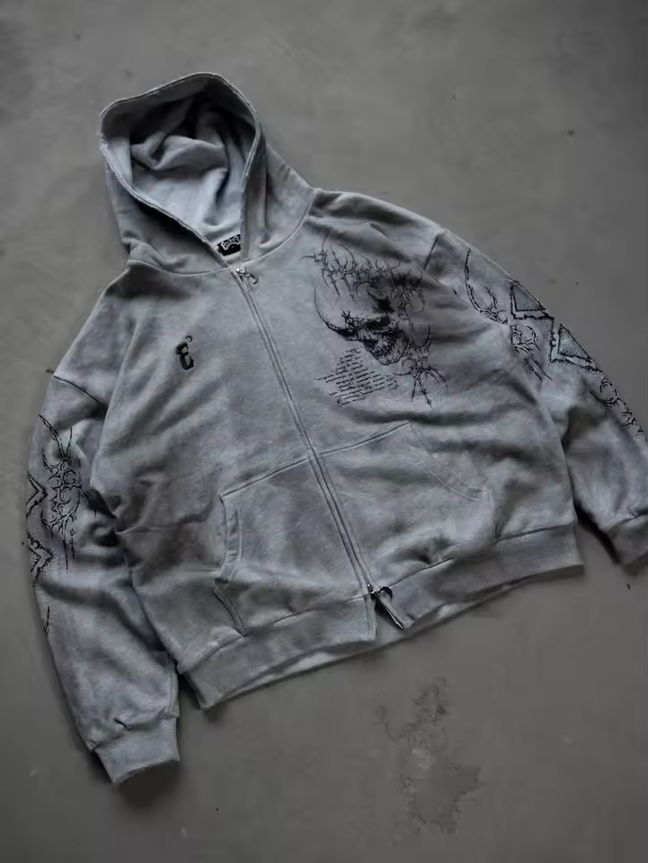 Angled view highlighting the drop-shoulder boxy fit of the heather grey Berserk sacrifice zip-up hoodie
