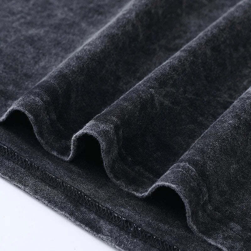 Close up detail of double-needle stitching and folded thick cotton fabric on a vintage black oversized t-shirt