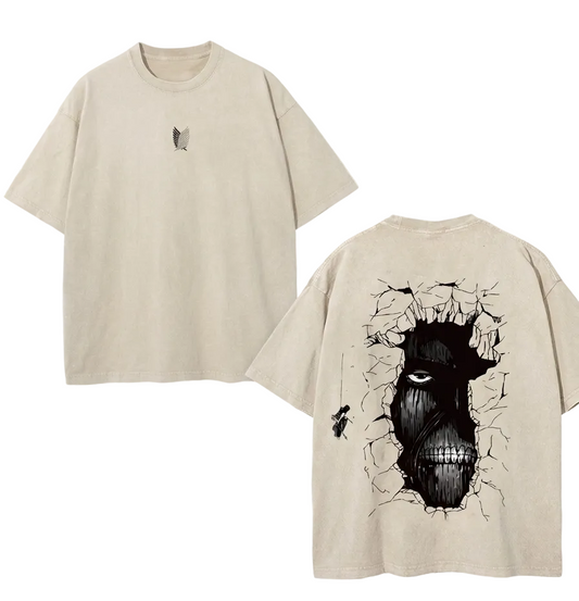 Front and back view of 240 GSM vintage sand acid wash tee. Front features center-chest Survey Corps logo. Back features massive Wall Titan face breaking through cracked wall graphic.