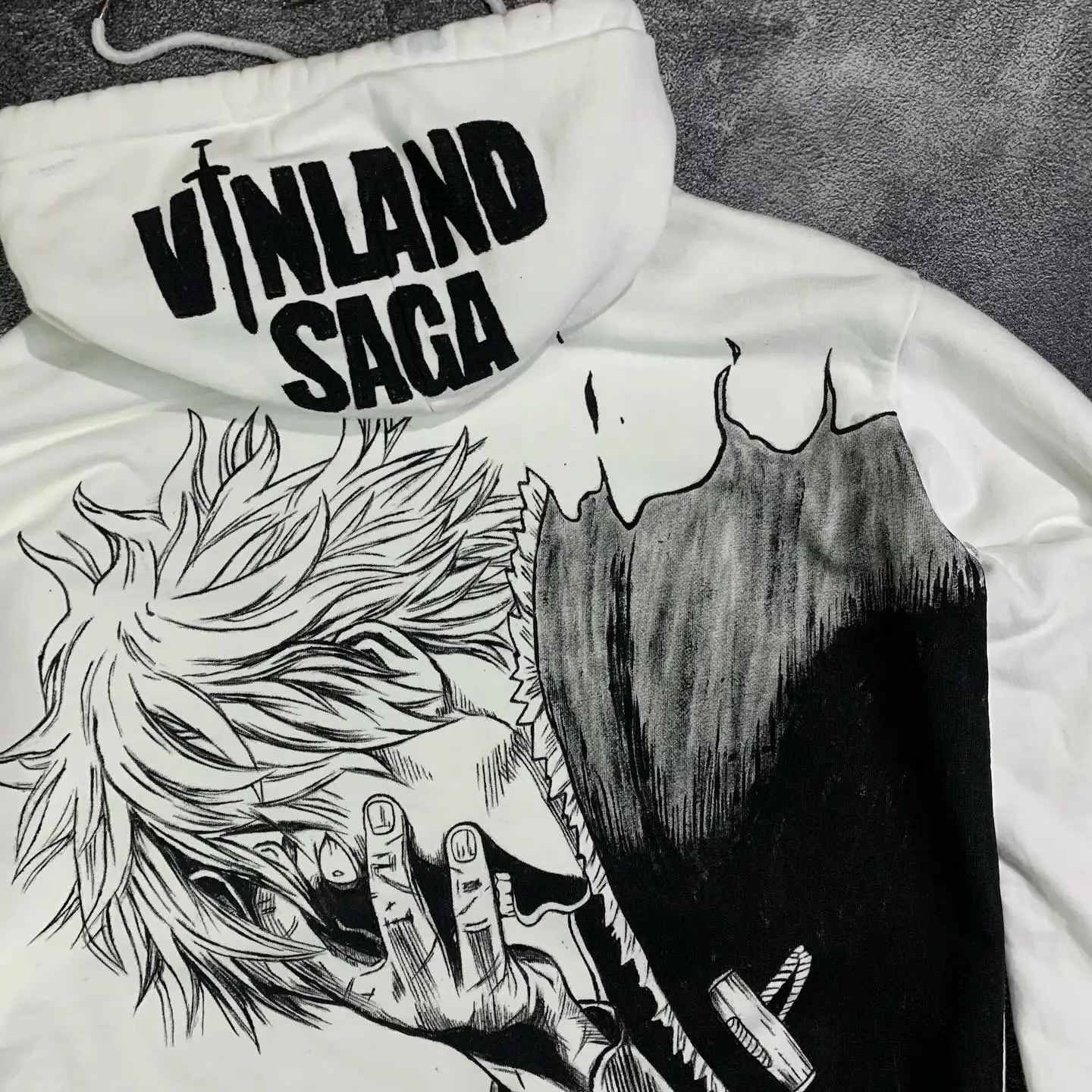 Angled close-up of the high-contrast black ink Thorfinn graphic on a premium white cotton SkaiiyPrints hoodie.